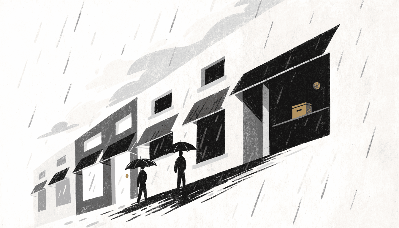 A rain-streaked street of small shopfronts under a grey sky, with a donation box on a counter inside one window and umbrella-carrying silhouettes passing.
