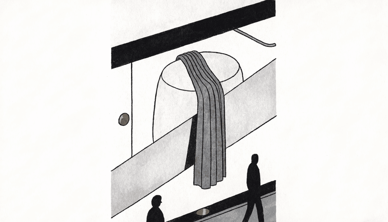 A boutique window at dusk with a pleated technical-fabric stole draped on a display form, silhouetted passersby glancing in from the street